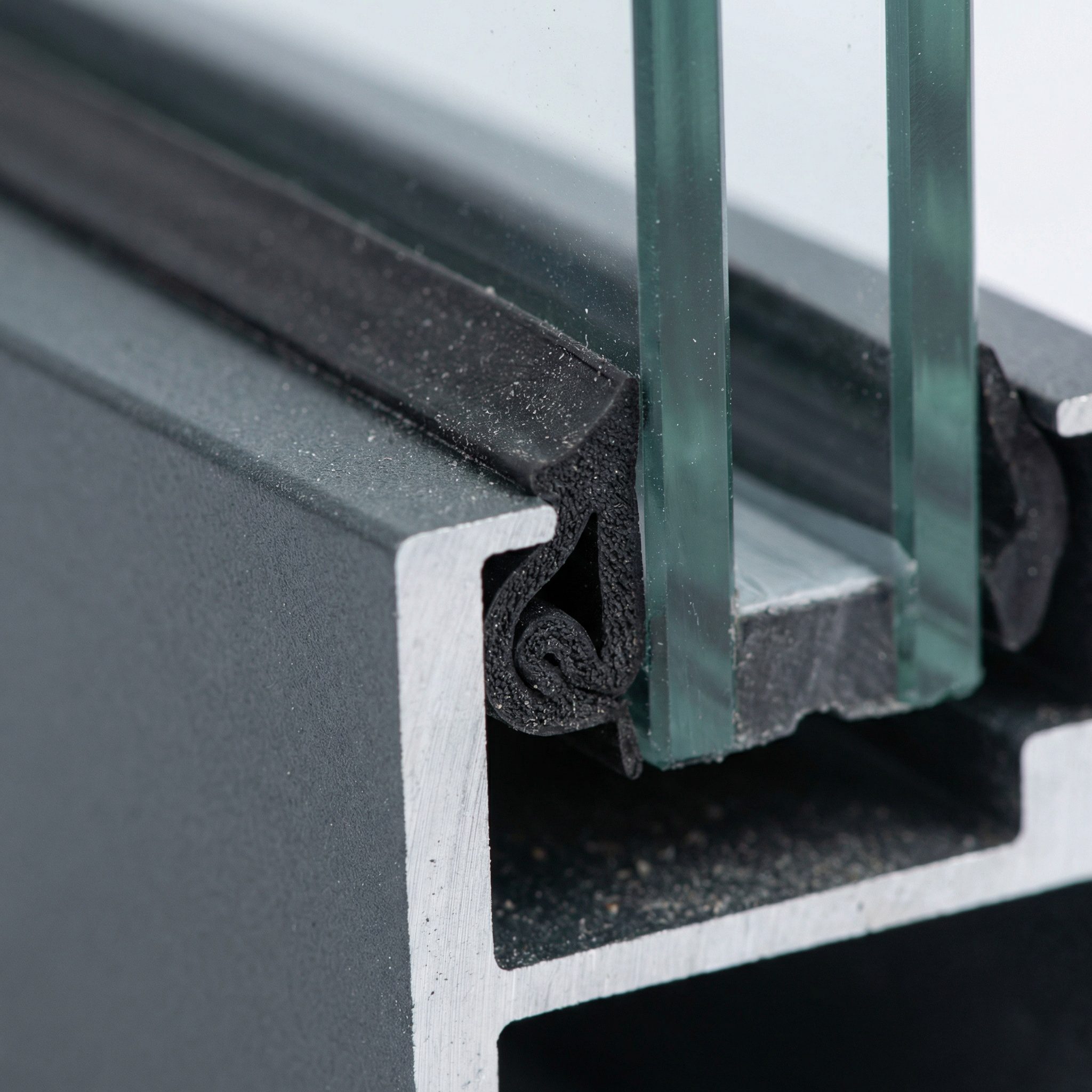 Close-up of aluminium shop front frame showing slim profile and toughened glass