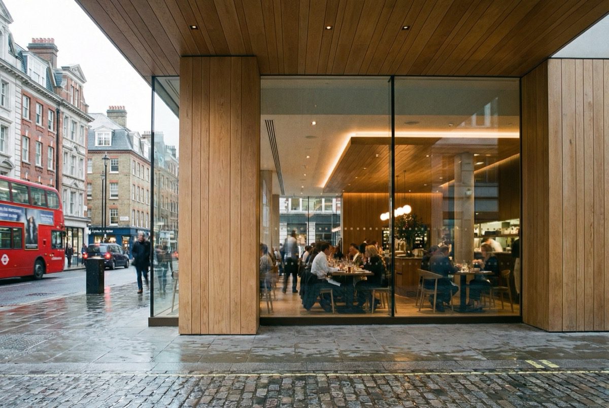 Hybrid timber and glass shop front combining wooden frame with large glazed panels