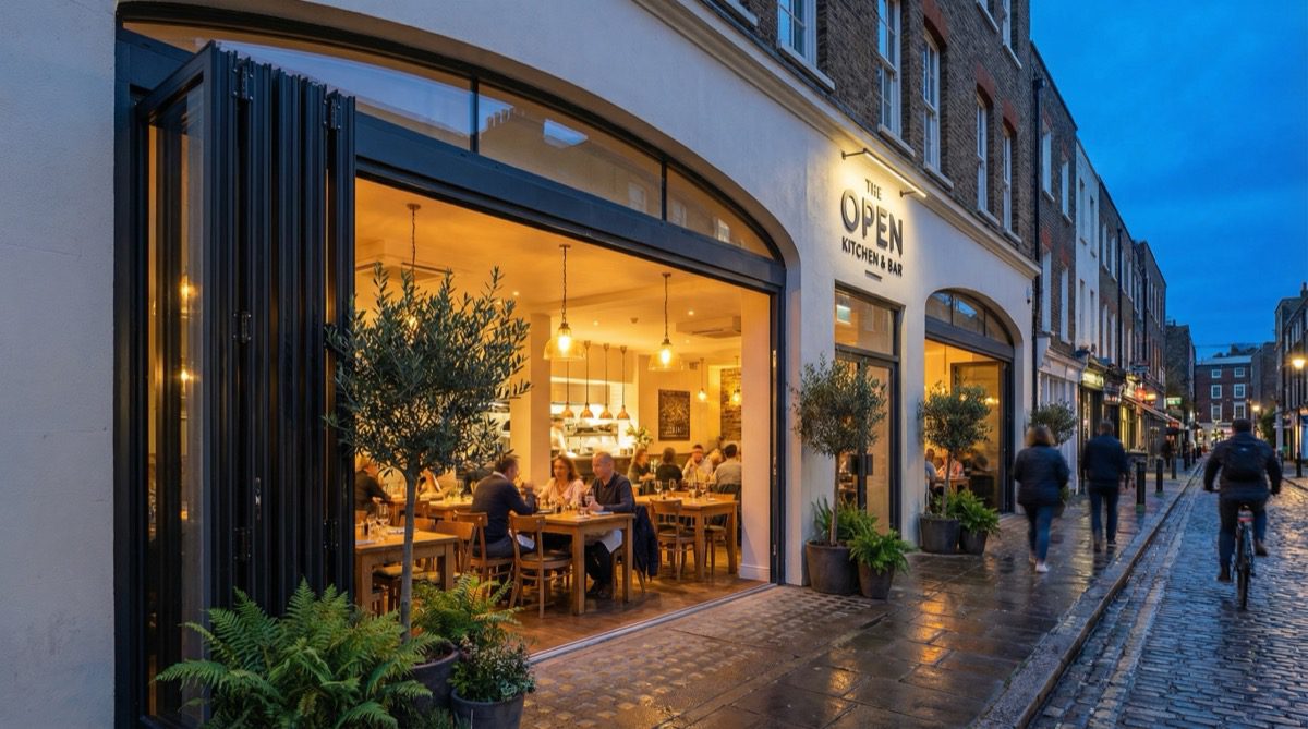 Restaurant with large commercial bifold doors fully open at dusk