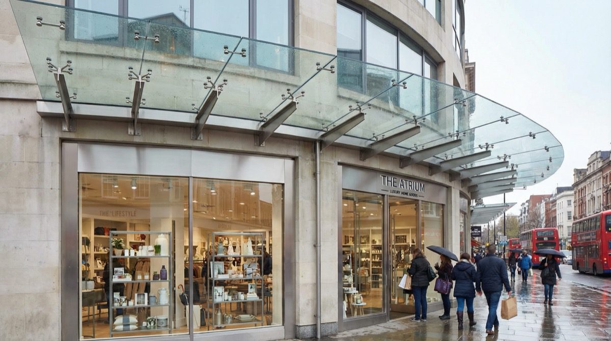 Modern glass canopy on a commercial shop front